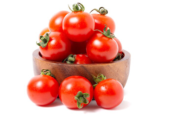 Ripe red tomatoes in a wooden bowl. isolated on white background.