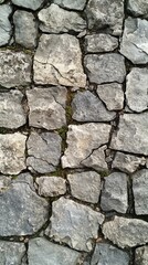 Obraz premium Serene Texture of a Stone Wall with Moss Growing in the Cracks Capturing Natural Beauty and Timeless Appeal for Backgrounds and Textures