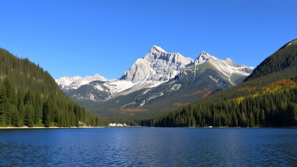 Fototapeta premium A serene lake reflects the majestic snow-capped mountains under a clear blue sky, surrounded by lush forests and autumn foliage, creating a tranquil and picturesque natural landscape. 