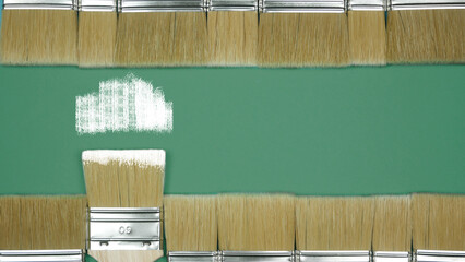 Brushes for painting walls horizontally in two rows. Place for text