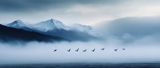 Serene Landscape of Mountains and Flying Birds in Misty Atmosphere