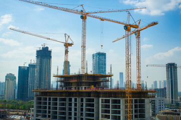 Fototapeta premium City building construction sites development and tower cranes. Generative AI