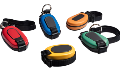 A set of pet training clickers with wrist straps, isolated on a empty plain background