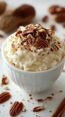 Creamy rice pudding topped with toasted pecans and a sprinkle of cinnamon on a bright kitchen table