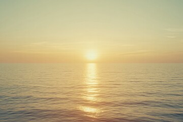 Obraz premium Calm ocean reflecting warm sunset, creating serene atmosphere of