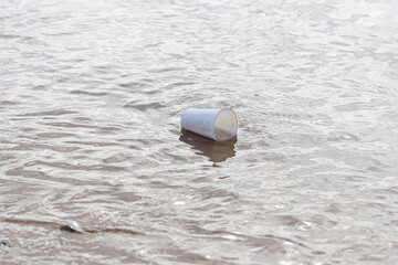 A plastic cup floating in the sea.