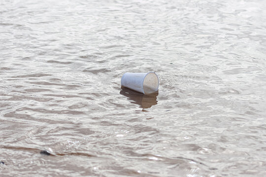 A plastic cup floating in the sea.