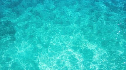 Crystal-clear turquoise water ripples gently, revealing vibrant