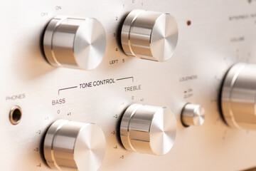 Close-Up of Audio Equipment Control Panel with Metal Knobs and Labels