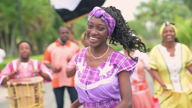 Portrait of a beautiful girl from the Garifuna ethnic group wearing a beautiful traditional costume in lilac color.
