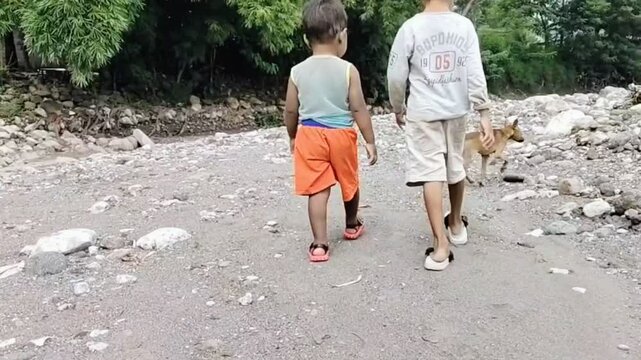 Two children's walking with puppy or dog