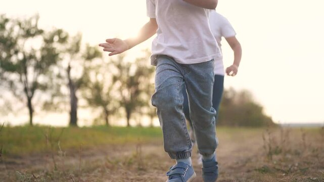Children running the forest in the park. happy family kid dream concept. a group of kids are running together in a park. a group of children and kids running together lifestyle in a park in forest.