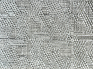 Close up of 3d textured grey fabric in random geometrical lines woven to one another. Seamless...