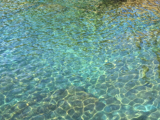 Crystal clear emerald sea water surface 