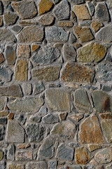Intricate textures of an ancient stone wall captured during bright daylight in a historic location