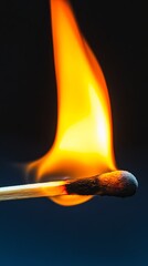 A close-up view of a matchstick in the process of ignition, showcasing the bright yellow flame and intense energy, perfect for concepts of risk and passion.