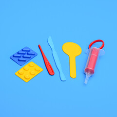 A toy medical kit for children playing doctor. A scalpel, a thermometer, medicines and a syringe for a children's role-playing game in an ambulance.