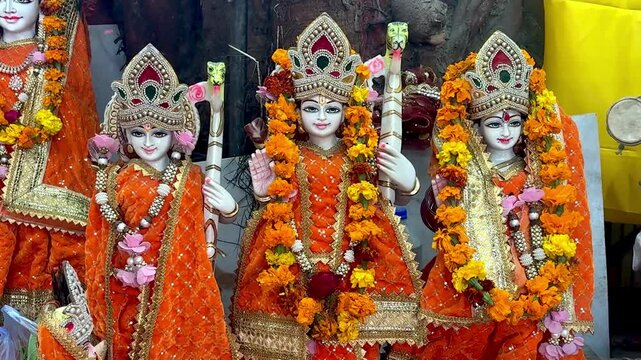 Lord Rama and Sita and Laxman statue in temple , with flowers in neck, cuteness face and Indian culture and god and goddess