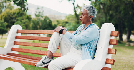 Knee pain, fitness and mature woman in park with injury, muscle strain and inflammation on bench....