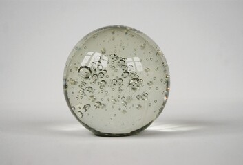 Close up on crystal ball with air bobbles.