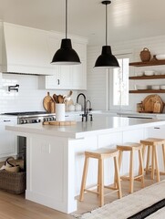 A bright white kitchen with black lights and stools