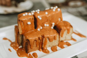 A plate of food with a brown sauce on it. The sauce is
drizzled over a stack of food