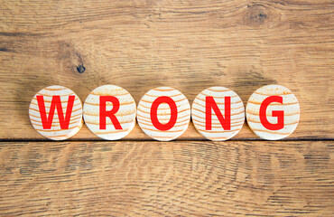 Wrong symbol. Concept word Wrong on beautiful wooden circles. Beautiful wooden table wooden...