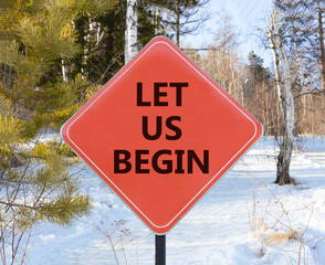 Let us begin symbol. Concept words Let us begin on beautiful red road sign. Beautiful snow forest...