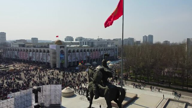 Monument, sculpture of Alai Manas on horseback, from heroic epic of Kyrgyz people. Nooruz celebration. Ala-Too main city square. Aerial. Bishkek, Kyrgyzstan - 21 MAR 2023