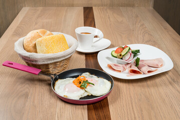 A nutritious and vibrant breakfast spread featuring eggs ham bread salad and a cup of coffee ready to enjoy