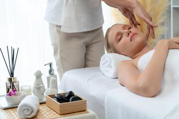 Caucasian woman enjoying relaxing anti-stress head massage and pampering facial beauty skin...
