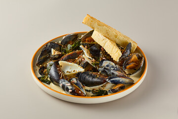 Exquisite Mussels in Creamy Sauce with Artisan Bread on Rustic Plate