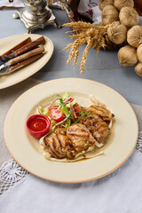 Grilled Chicken Thigh Skewers with Vegetables and Red Sauce on Rustic Table