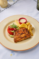 Grilled Trout with Baked Potatoes and Fresh Vegetable Salad in Vibrant Natural Light