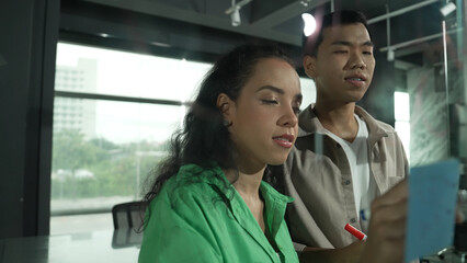 Portrait of hispanic employee present start up marketing idea while investor standing and...