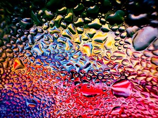 Close-up of water drops on metal surface in high resolution showing condensation of water droplets on metal surface. Intricate patterns and different sized water droplets create a beautiful abstract