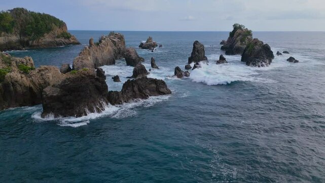 Drone view of Sharks Teeth Beach with its jagged rock formations and crashing waves at the daytime