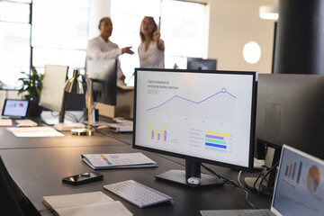 Discussing digital analytics, office diverse professionals in meeting room with computer screen