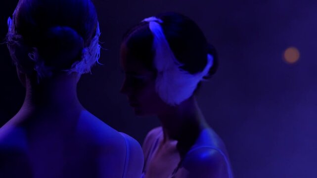 A ballet dancer in a tutu and earflaps performs on stage during Swan Lake, creating a unique blend of tradition and unexpected style. 