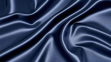 Obraz premium Smooth satin background in deep navy blue, reflecting light elegantly: A soft and luxurious navy-blue satin fabric, draped smoothly with subtle folds, reflecting light in a gentle, elegant manner,
