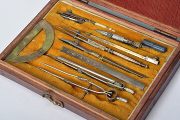 Antique technical drawing set  in steel and brass with compass, nibs and protractor in wooden box