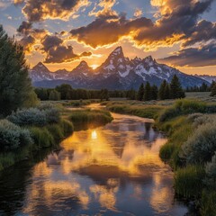 Serene sunset illuminating the Grand Teton mountains reflected in the Snake river with golden light and dramatic clouds creating a tranquil and majestic landscape view