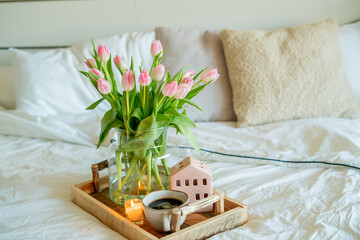 Home spring decor, bouquet of tulips in vase, hot coffee.