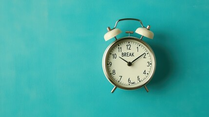 A vintage alarm clock displaying the word "BREAK" on a vibrant turquoise background, symbolizing relaxation and time management.