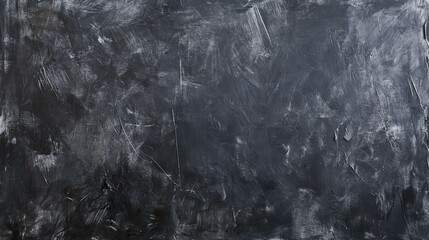 Textured grey chalkboard surface with erased marks for background or design