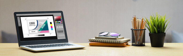 Graphic designer software for modern design of web page and commercial ads showing on the computer screen