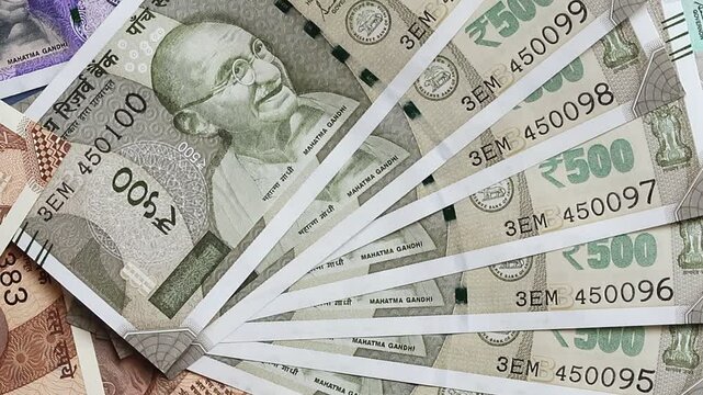 Close-up of indian rupees banknotes of different values. Top view video footage with slow rotation.