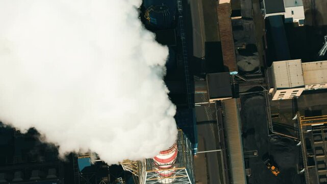 Heavy smoke billows from coal power plant stacks, contributing to air pollution 