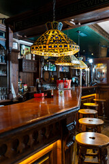 Empty bar counter illuminating warm light with tiffany lamps