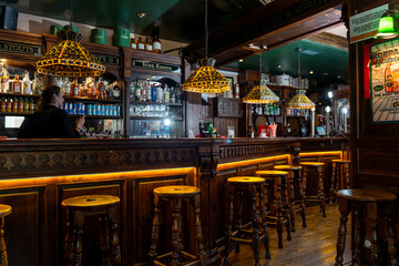 Cozy irish pub interior with wooden bar stools